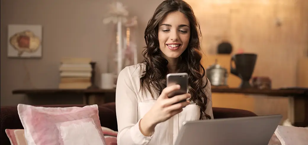 Young woman reading website reviews from her phone