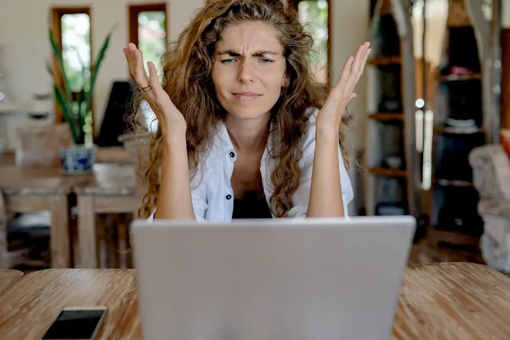 Local Business Owner Asking Why Aloud in front of laptop