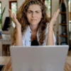 Local Business Owner Asking Why Aloud in front of laptop