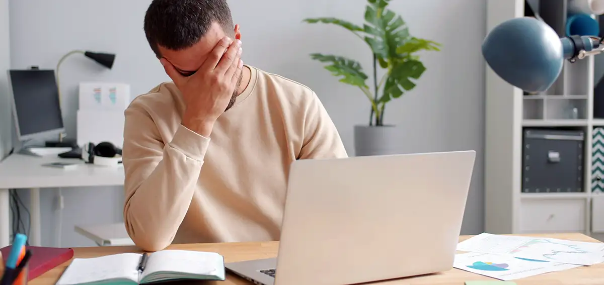 Man frustrated with website problems with using laptop