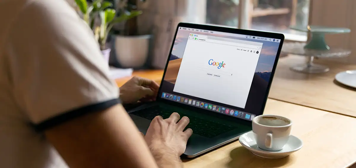 Person typing on a laptop while on Google