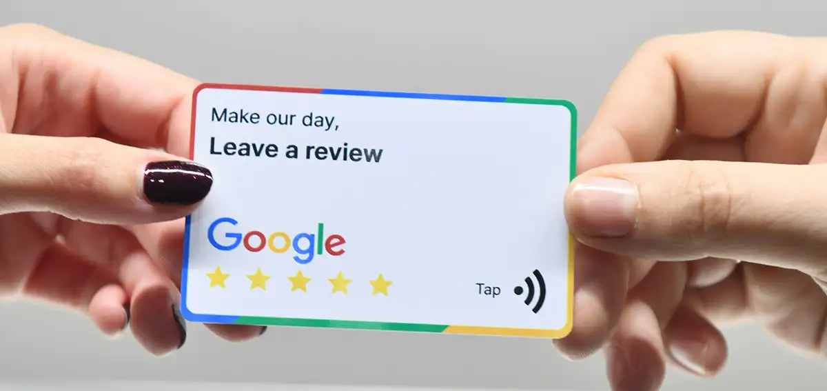 Fingers holding a Google Review card