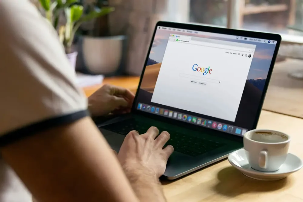 Person doing a search using Google on a laptop